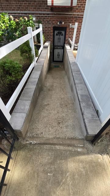 Finished concrete basement entrance walkway and capped walls