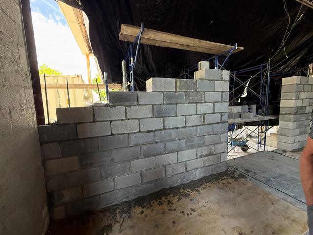 New concrete block wall rising during a commercial wall reconstruction