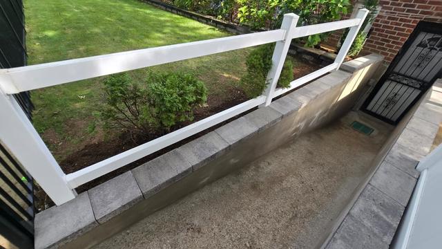 New concrete wall caps and finished areaway next to a lawn