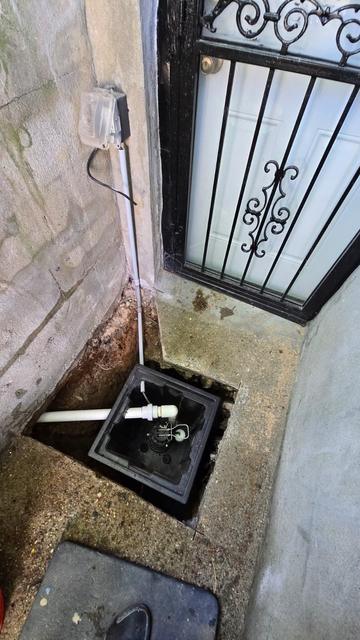 New sump basin installed at a basement entrance stairwell