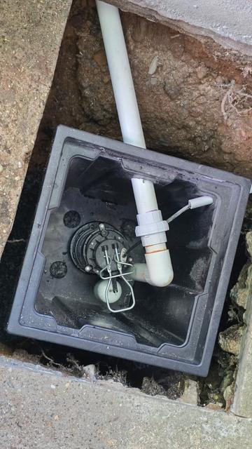 Sump pump and PVC discharge line installed in a new basin